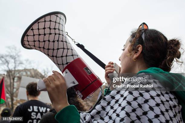 Demonstrator wearing the traditional Palestinian Keffiyeh shouts slogans while joining in a demonstration. Pro-Palestinian demonstrators gather at...