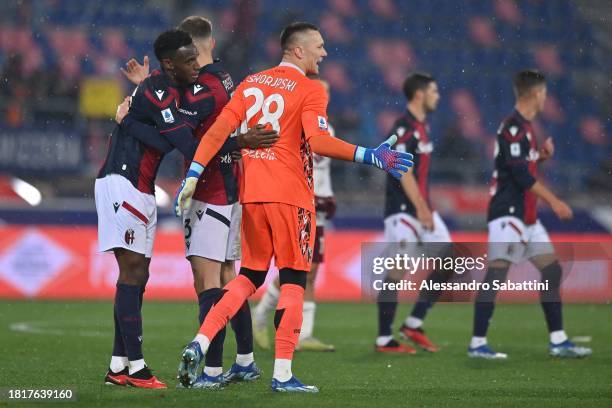 Jhon Lucumí of Bologna FC embraces Lukasz Skorupski of Bologna FC during the Serie A TIM match between Bologna FC and Torino FC at Stadio Renato...