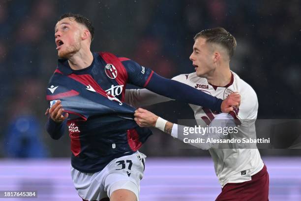 Sam Beukema of Bologna FC competes for the ball with Ivan Ilić of Torino FC during the Serie A TIM match between Bologna FC and Torino FC at Stadio...