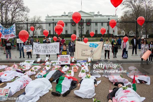 Activists representing victims in Gaza, lay on the ground in front of the White House during a silent demonstration "Die-in for Humanity" organized...