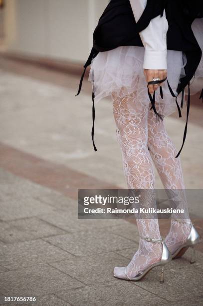 A guest wears white lace tights, white tutu or tule skirt, black
