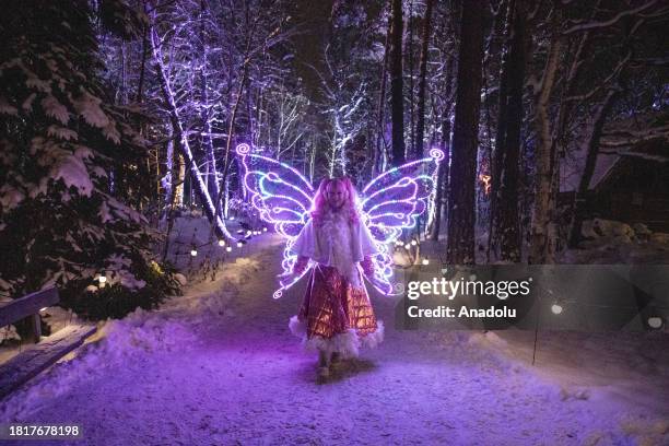 Young woman wearing a fairy costume-lit is photographed at the Winter Lights decoration tour during the traditional Christmas celebration at Skansen...