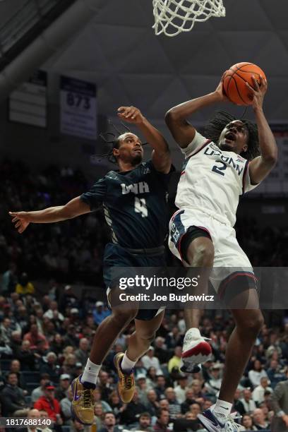 Tristen Newton of the Connecticut Huskies is fouled by Ahmad Robinson of the New Hampshire Wildcats during the second half at the Harry A. Gampel...