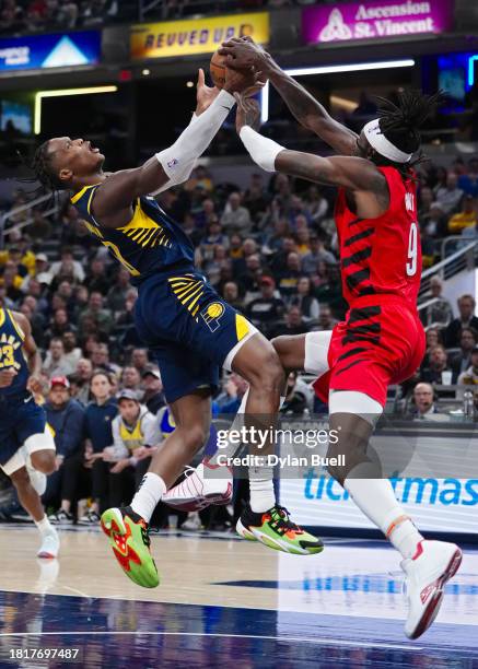 Bennedict Mathurin of the Indiana Pacers and Jerami Grant of the Portland Trail Blazers battle for the ball in the fourth quarter at Gainbridge...