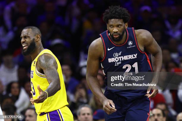 LeBron James of the Los Angeles Lakers reacts behind Joel Embiid of the Philadelphia 76ers during the third quarter at the Wells Fargo Center on...