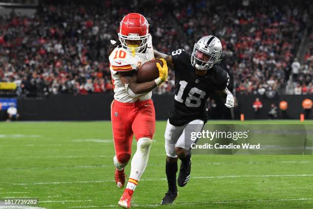 Running back Isiah Pacheco of the Kansas City Chiefs is forced out of bounds by cornerback Jack Jones of the Las Vegas Raiders in the fourth quarter...