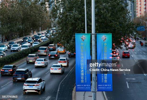 Posters promoting the upcoming first China International Supply Chain Expo hang on the lamppost on November 27, 2023 in Beijing, China. The first...