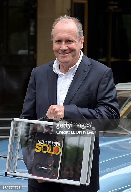 British author William Boyd poses with his new James Bond novel "Solo" during a photo call a day ahead of its release in central London on September...