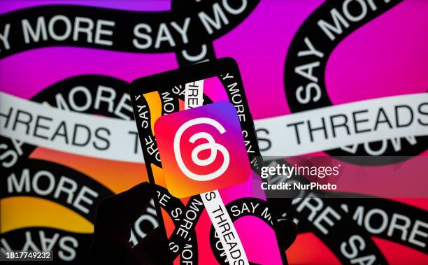The Meta - Threads logo is being displayed on a smartphone with... News ...