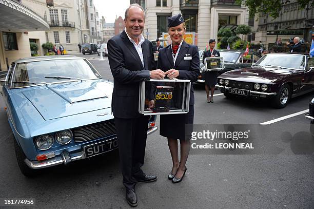 British author William Boyd poses with his new James Bond novel "Solo" and British Airways ambassador Helena Flynn during a photo call a day ahead of...