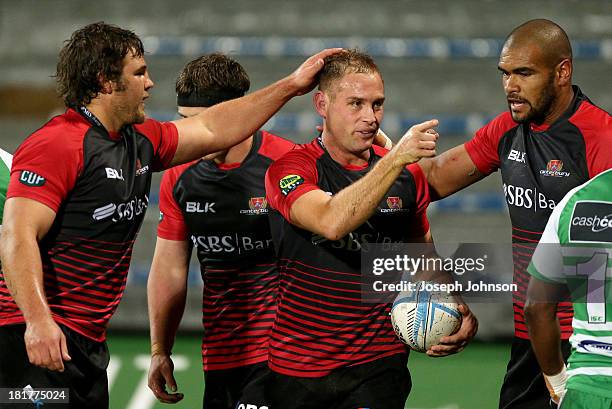 Andy Ellis of Canterbury is congratulated by Ben Funnell and Patrick Osborne after his try during the round 7 ITM Cup match between Canterbury and...