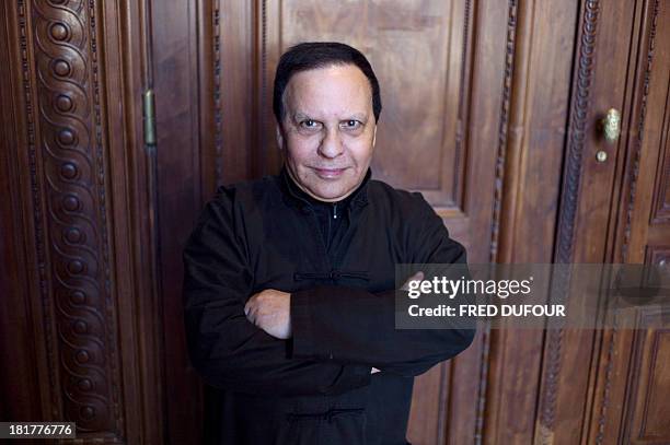 French designer Azzedine Alaia poses during his exhibition at the Palais Galliera, on September 25 in Paris. AFP PHOTO / FRED DUFOUR