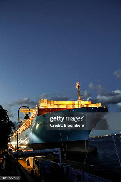 Shipping containers stand illuminated at night on the prow of the Majestic Maersk Triple E class ship, one of the world's largest vessels, operated...