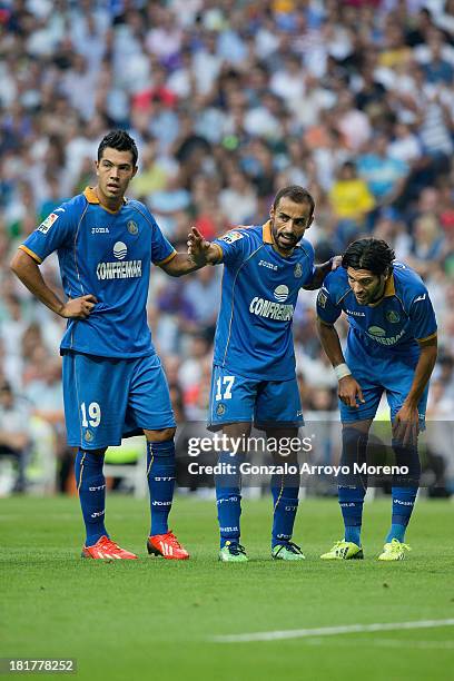 Diego Castro of Getafe CF gives instructions to his teammate Angel Lafita in company with Nicolas Ladislao alias Miku during the La Liga match...