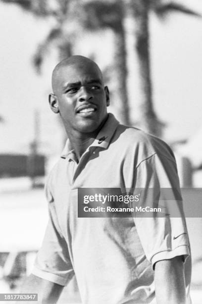 Chris Webber of the Golden State Warriors walks on the beach wearing a polo shirt with the Nike swoosh on the collar and sleeve during the filming of...