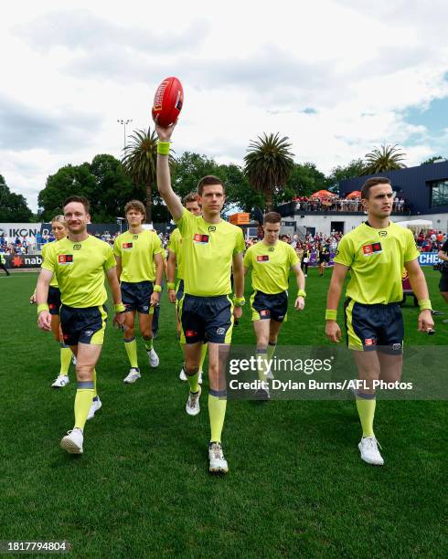 The umpires enter the field before the 2023 AFLW Grand Final match between The North Melbourne Tasmanian Kangaroos and The Brisbane Lions at IKON...