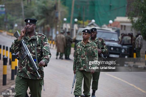 Kenyan security personal stand guard outside the Westgate Shopping Centre, on September 25, 2013 in Nairobi, Kenya. The country is observing three...