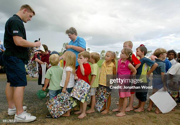 Brent Tate signs autographs during the NRL Promotion to outback communities at the town of Mitchell in Queensland, Australia on February 25, 2003.