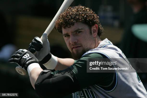 Jonny Gomes of the Tampa Bay Devil Rays gets ready in the dugout as he takes practice swings prior to his at bat during MLB game action against the...