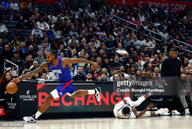 Kawhi Leonard of the LA Clippers steals the ball in front of Reggie Jackson of the Denver Nuggets in the first quarter at Crypto.com Arena on...