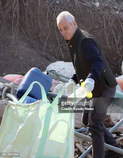 Ambassador to Japan Rahm Emanuel picks up plastic litter during a beach clean-up in Tsushima, Nagasaki Prefecture, southwestern Japan, on Dec. 3,...