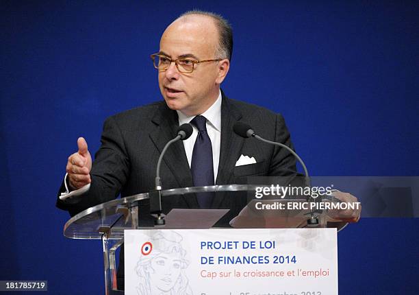 French Budget Minister Bernard Cazeneuve talks during a press conference to explain next year's draft budget "PLF 2014" at the Economy Ministry in...