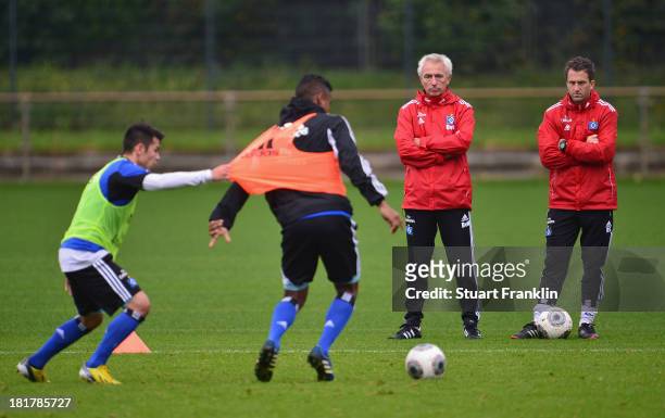 Bert van Marwijk, watches during his first training session as head coach of Hamburg SV with his assistant trainer, Roger Stilz on September 25, 2013...
