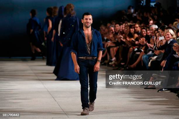 French fashion designer Alexis Mabille acknowledges the public during the 2014 Spring/Summer ready-to-wear collection fashion show, on September 25,...