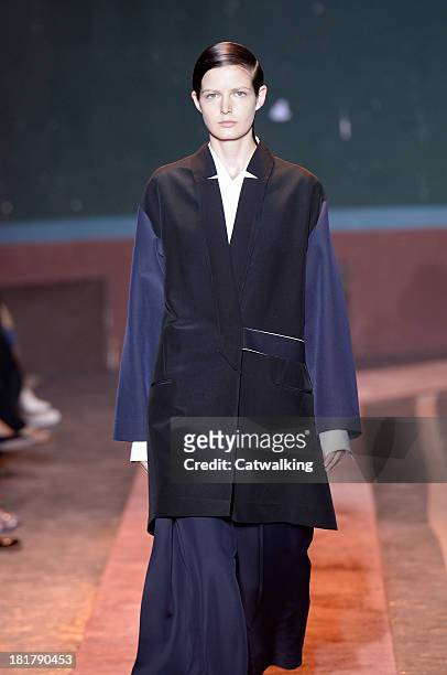 Model walks the runway at the Cedric Charlier Spring Summer 2014 fashion show during Paris Fashion Week on September 24, 2013 in Paris, France.