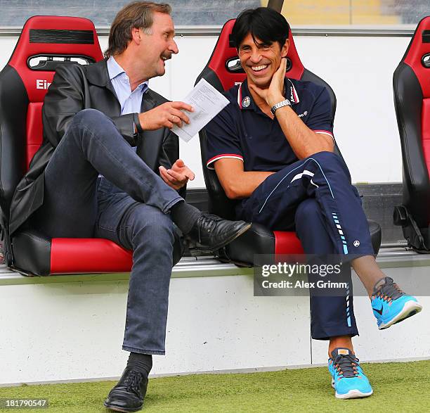 Head coach Peter Neururer of Bochum chats with manager Bruno Huebner of Frankfurt prior to the DFB Cup second round match between Eintracht Frankfurt...