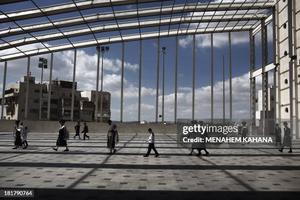 Ultra-Orthodox Jews of the Belz Hasidic Dynasty walk leave the synagogue after the prayers during the last day of Sukkot, or the feast of the...