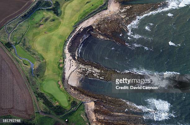 An aerial view of the par 5, 12th hole along the beach and the par 3, 13th hole on the course at Kingsbarns during practice for the 2013 Alfred...