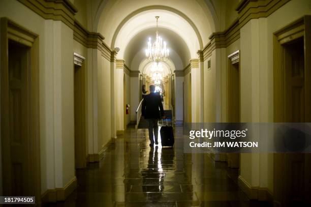 Man walks through the hallway of the US Capitol on September 25 after US Senator Ted Cruz ended his talk-a-thon on the floor of the US Senate in...