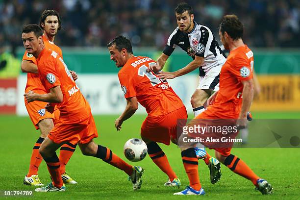 Tranquillo Barnetta of Frankfurt is challenged by Marcel Maltritz, Patrick Fabian and Paul Freier of Bochum during the DFB Cup second round match...