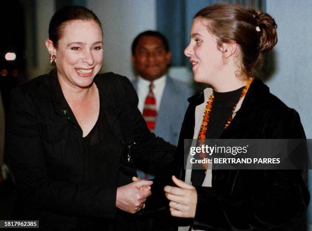 Alina Fernandez and her daughter Alina Maria respectively daughter and granddaughter of Cuban leader Fidel Castro, laugh while coming out of a press...