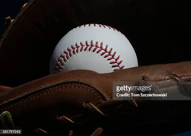 Baseball rests inside the catcher's glove of Chris Snyder of the Baltimore Orioles before the start of MLB game action against the Toronto Blue Jays...
