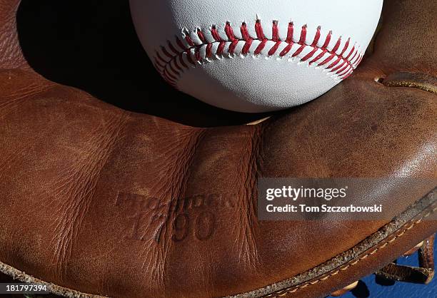 Baseball rests inside the catcher's glove of Chris Snyder of the Baltimore Orioles before the start of MLB game action against the Toronto Blue Jays...