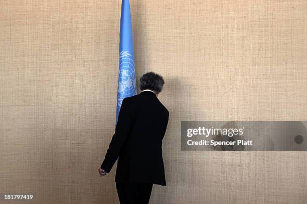 An aide postions a United Nations flag during the annual U.N. General Assembly in New York on September 25, 2013 in New York City. Over 120 prime...