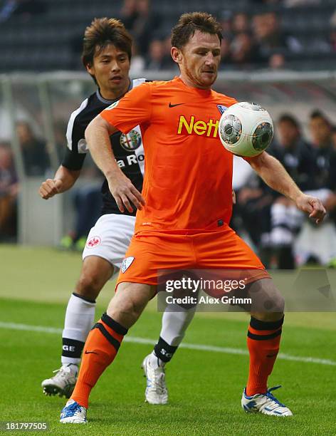 Paul Freier of Bochum is challenged by Takashi Inui of Frankfurt during the DFB Cup second round match between Eintracht Frankfurt and VfL Bochum at...