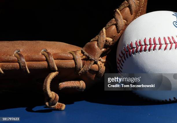 Baseball rests beside the catcher's glove of Chris Snyder of the Baltimore Orioles before the start of MLB game action against the Toronto Blue Jays...