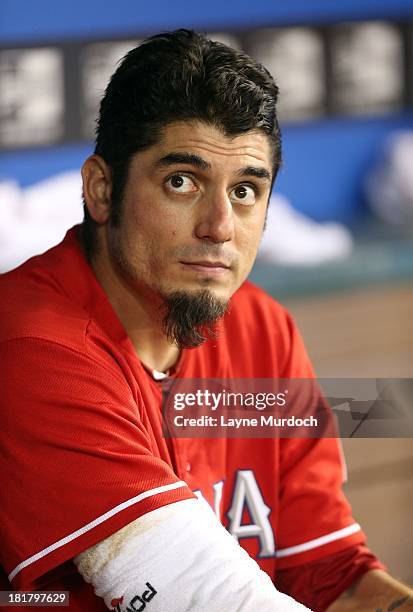 Matt Garza, starting pitcher of the Texas Rangers watches front he dugout against the Houston Astros on August 19, 2013 at the Rangers Ballpark in...
