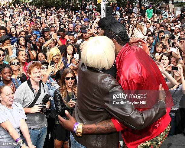 Queen diva Big Freedia hugs his mother after breaking the Guinness World Record for twerking at Herald Square on September 25, 2013 in New York City.