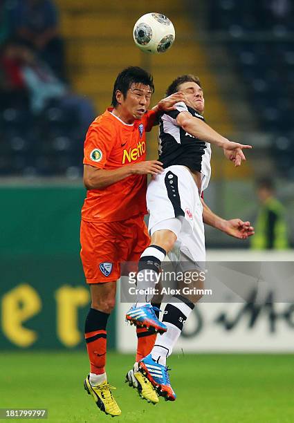 Yusuke Tasaka of Bochum jumps for a header with Sebastian Jung of Frankfurt during the DFB Cup second round match between Eintracht Frankfurt and VfL...