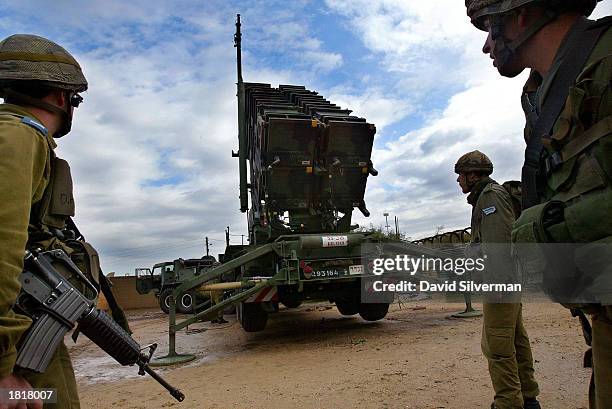 Israeli soldiers stand round a Patriot missile launcher February 27, 2003 as the anti-aircraft and anti-ballistic missile missile is made ready to...