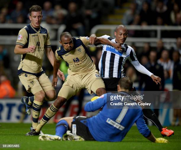 Yoan Gouffran of Newcastle United is foiled by Rodolph Austin and Paddy Kenny of Leeds United during the Capital One Cup Third Round match between...