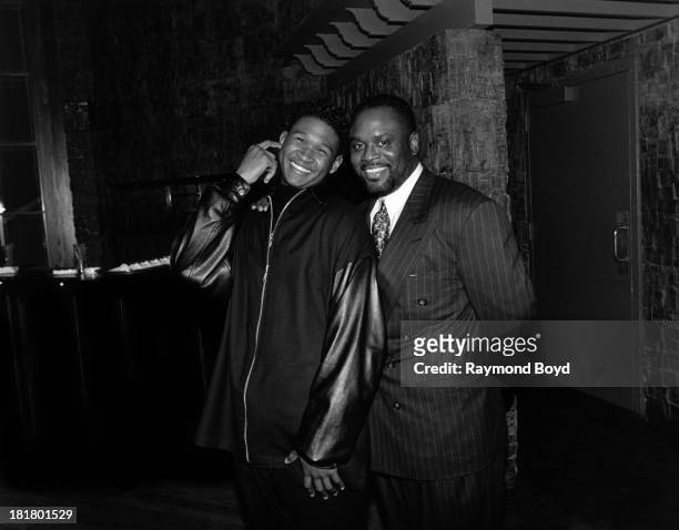 Singer Usher poses for photos with record executive L.A. Reid, at the Ritz-Carlton Hotel in Chicago, Illinois in JANUARY 1995.