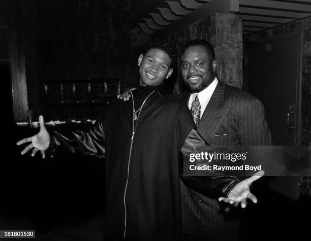 Singer Usher poses for photos with record executive L.A. Reid, at the Ritz-Carlton Hotel in Chicago, Illinois in JANUARY 1995.