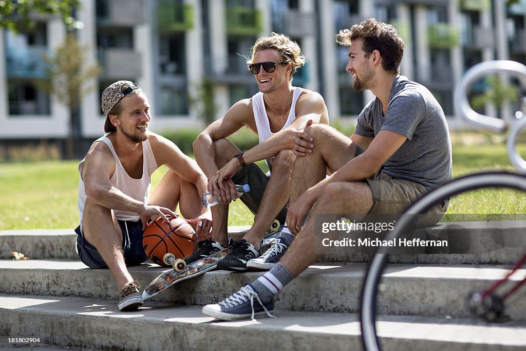 Three young men sitting and chatting