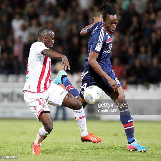 Ajaccio's Franco-Malian midfielder Sigamary Diarra fights for the ball with Lyon's Burkinabe defender Bakary Kone on September 25, 2013 during a...