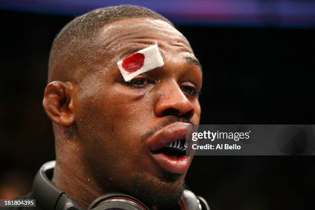 Jon 'Bones' Jones is tended to by a cut man after his fight against Alexander 'The Mauler' Gustafsson in their UFC light heavyweight championship...